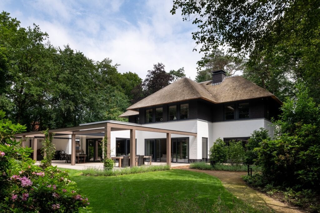 Moderne vrijstaande woning met tuin, terras en omringend groen.